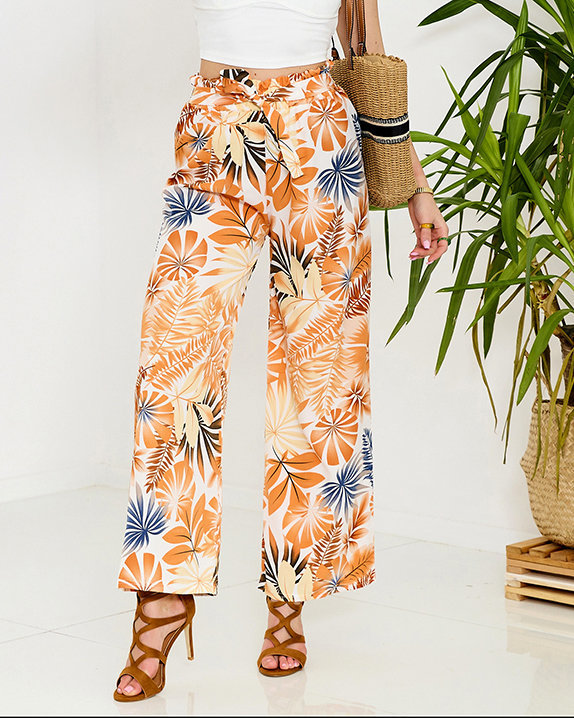 Royalfashion Biało-pomarańczowe damskie spodnie palazzo z roślinnym wzorem