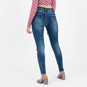 Granatowe jeansy damskie rurki z dziurami - Odzież