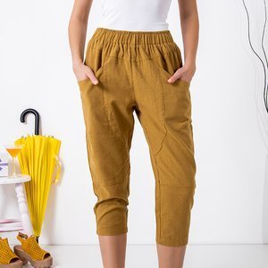Musztardowe damskie spodnie o długości 3/4 - Odzież
